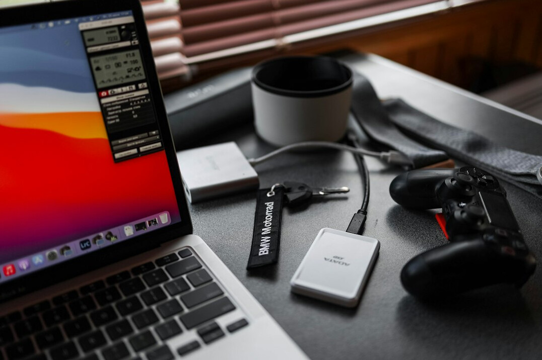 Streaming production setup with encoders and laptops on a desk